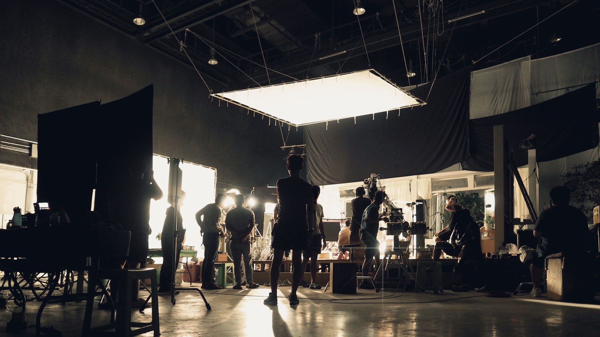 Silhouette of people working in big production studio